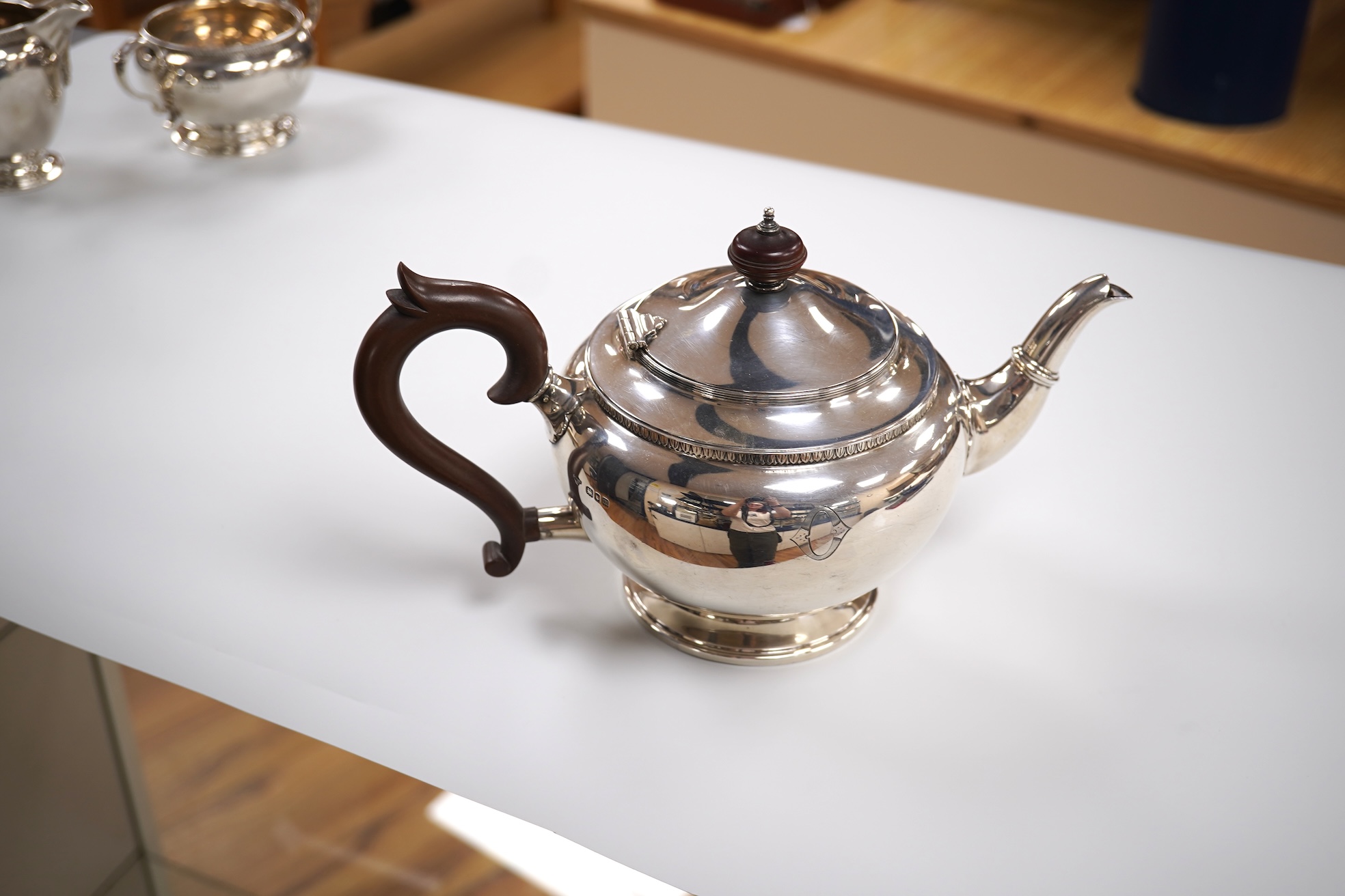A George V silver circular three piece tea set, with engraved initial, Fenton, Russell & Co Ltd, London, 1927, gross weight 32.4oz.